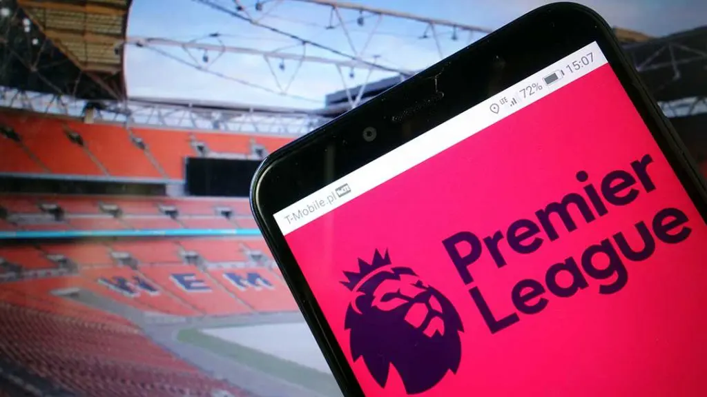 Smartphone displaying Premier League logo inside a football stadium, symbolising England’s top-flight league with 20 clubs playing from August to May